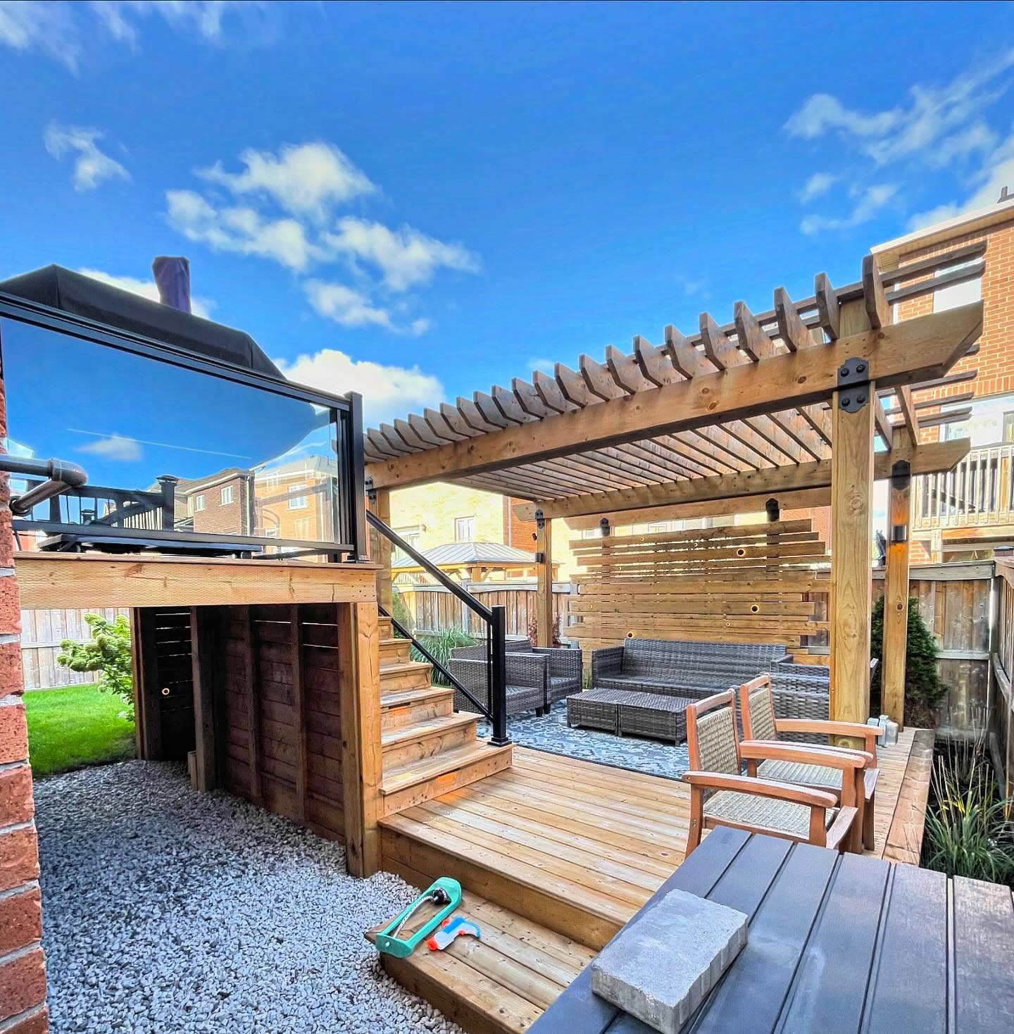 Multi-level cedar deck with pergola, slat privacy screen and under-deck storage